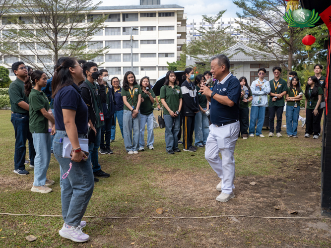 Tzu Chi volunteer Johnny Kwok explains the significance of the wooden cabin, a replica of the one Dharma Master Cheng Yen lived in during her beginnings as a Buddhist Nun.