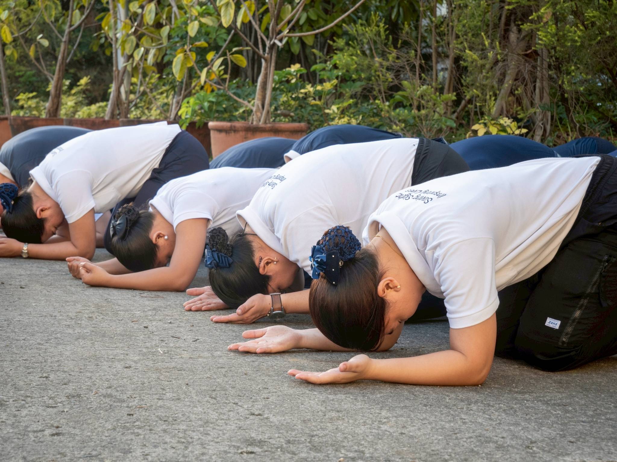 Participants bow in full prostration as a manifestation to foster deep humility and mindfulness.