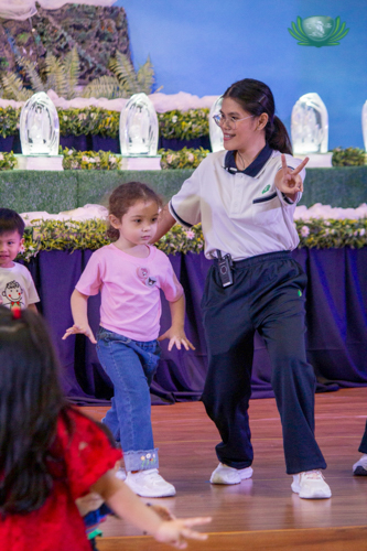Teacher Nadinne Galano dances with the students.