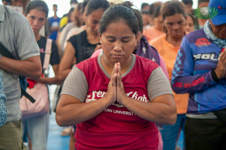 Lorina Caño offers a heartfelt prayer of thanks upon learning that she and her mother would receive assistance.