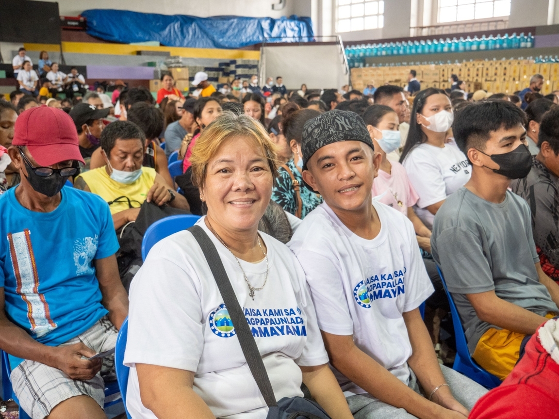 Beneficiaries smiling for a photo as they wait for the relief operations to begin.