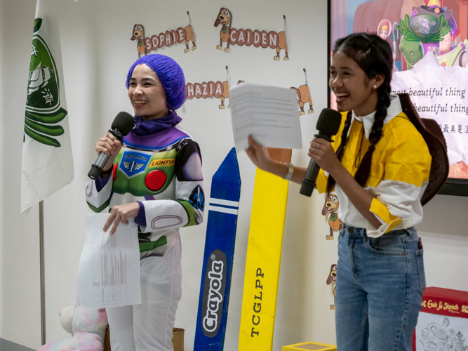 Teacher Yani (left) and Teacher Tin host the indoor Halloween event.