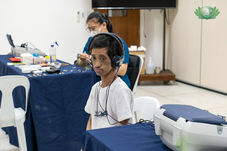 At the free hearing screening, Jasper Arreza undergoes a hearing test. He has Fanconi anemia, a condition marked by small stature, skin pigmentation, and hearing problems, among other symptoms. 