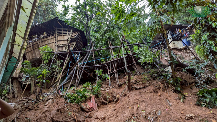 Homes made of light material stand precariously on a hill following a landslide from nonstop rains in Maly, San Mateo, Rizal.