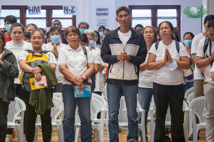 Medical assistance beneficiaries participate in a group prayer for good health and peace in the world. 