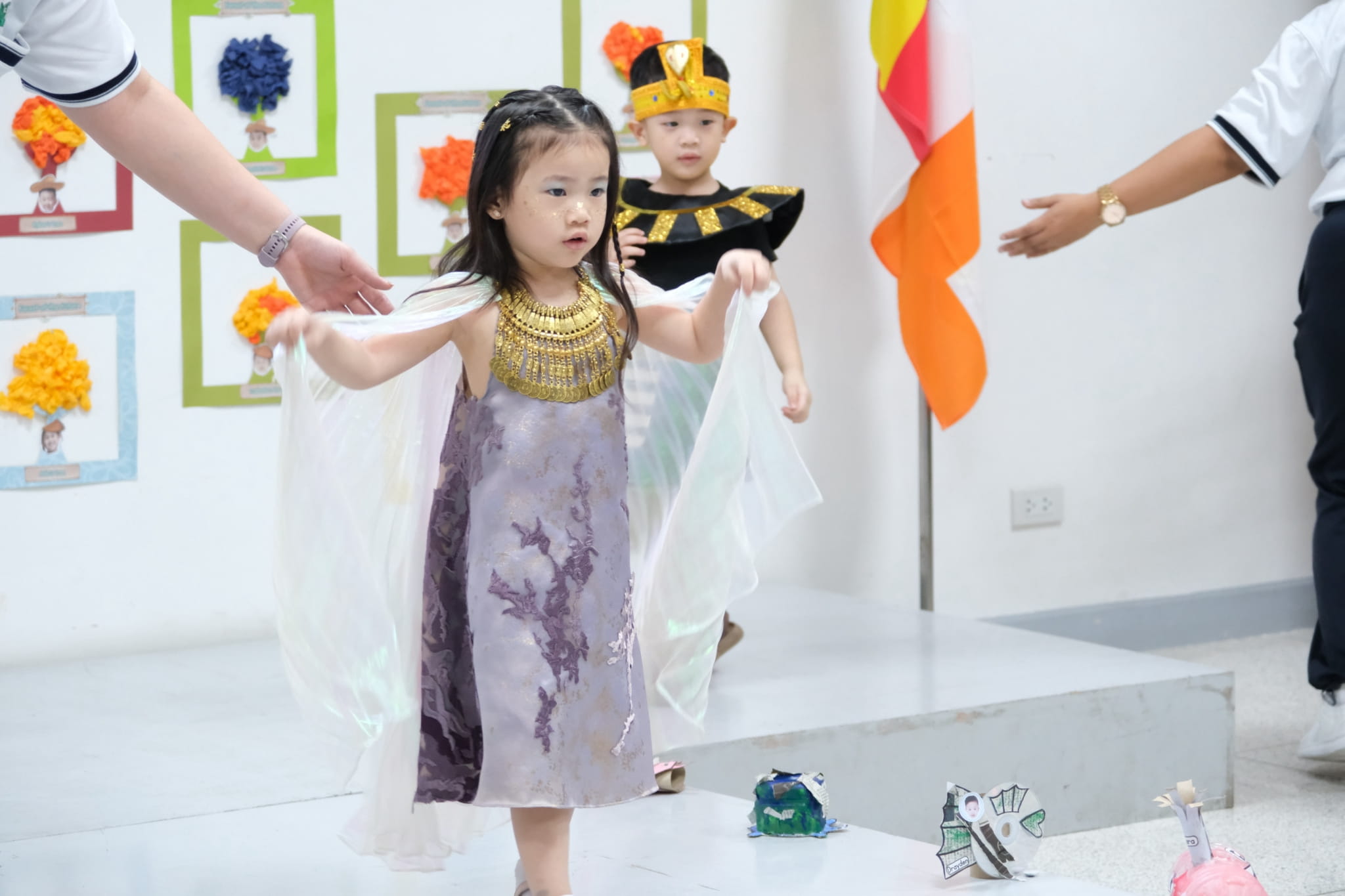 Preschoolers steal the spotlight in their colorful traditional costumes.
