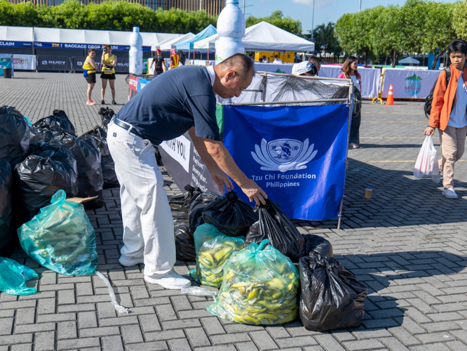 Runners disposed of their trash in large bins set up by Tzu Chi volunteers. From empty PET bottles to banana peels, the collected waste went to Tzu Chi’s recycling station. 【Photo by Matt Serrano】