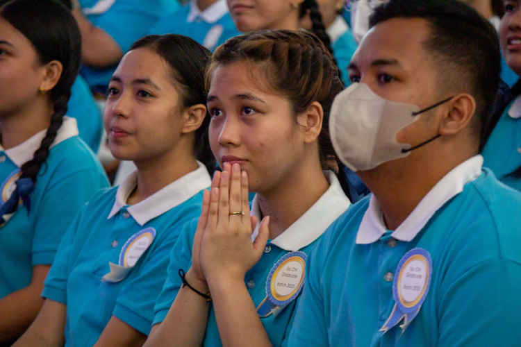 A scholar is moved by the life story of three graduating scholars presented in a short video. 【Photo by Marella Saldonido】  