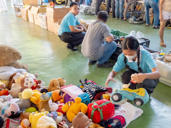 Tzu Chi scholar Sydney Alipao (right) made sure to carefully arrange the toys. “I immediately noticed the toys and arranged them, such as the blocks with numbers that I collected and arranged one by one,” Sydney shared. 【Photo by Dorothy Castro】
