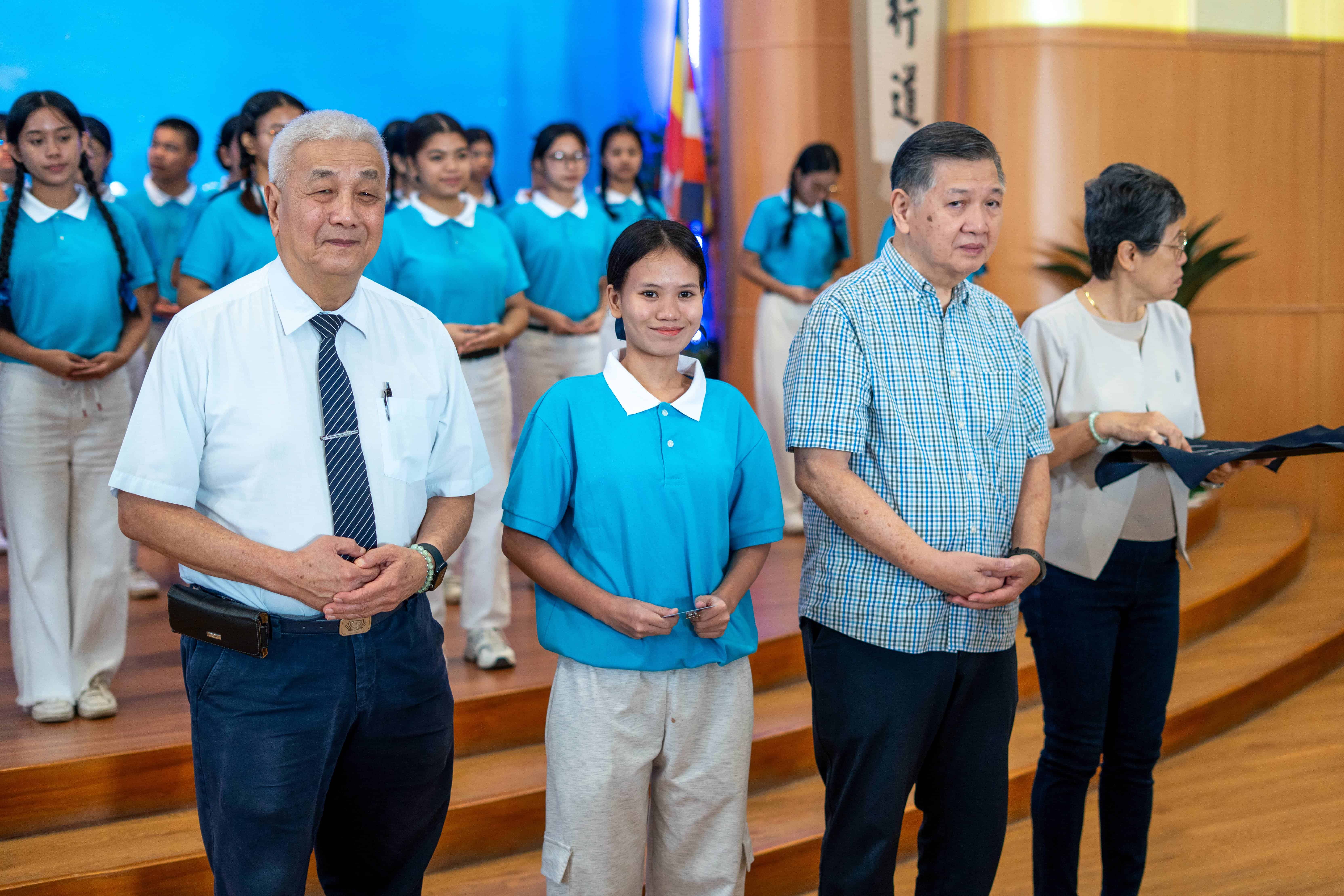 Tzu Chi Philippines CEO Henry Yuñez (left) and Nelson and Betty Sy of Neltex Development Co. Inc. (third and fourth from left) present Pamela Madel Gadon with  her official Tzu Chi scholar ID. 