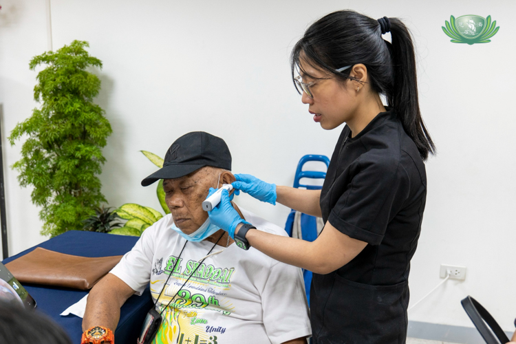 Dr. Joyce Rodvie M. Sagun performs an otoscopy (a visual examination of the ear canal and eardrum) on Arturo Labalan. A dispatcher at the airport, he was constantly exposed to the deafening sounds of airplane landings and take-offs. 