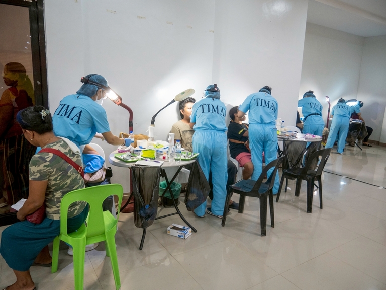 The dental team worked continuously, attending to patients one after another to help reduce the long queue in the waiting area.