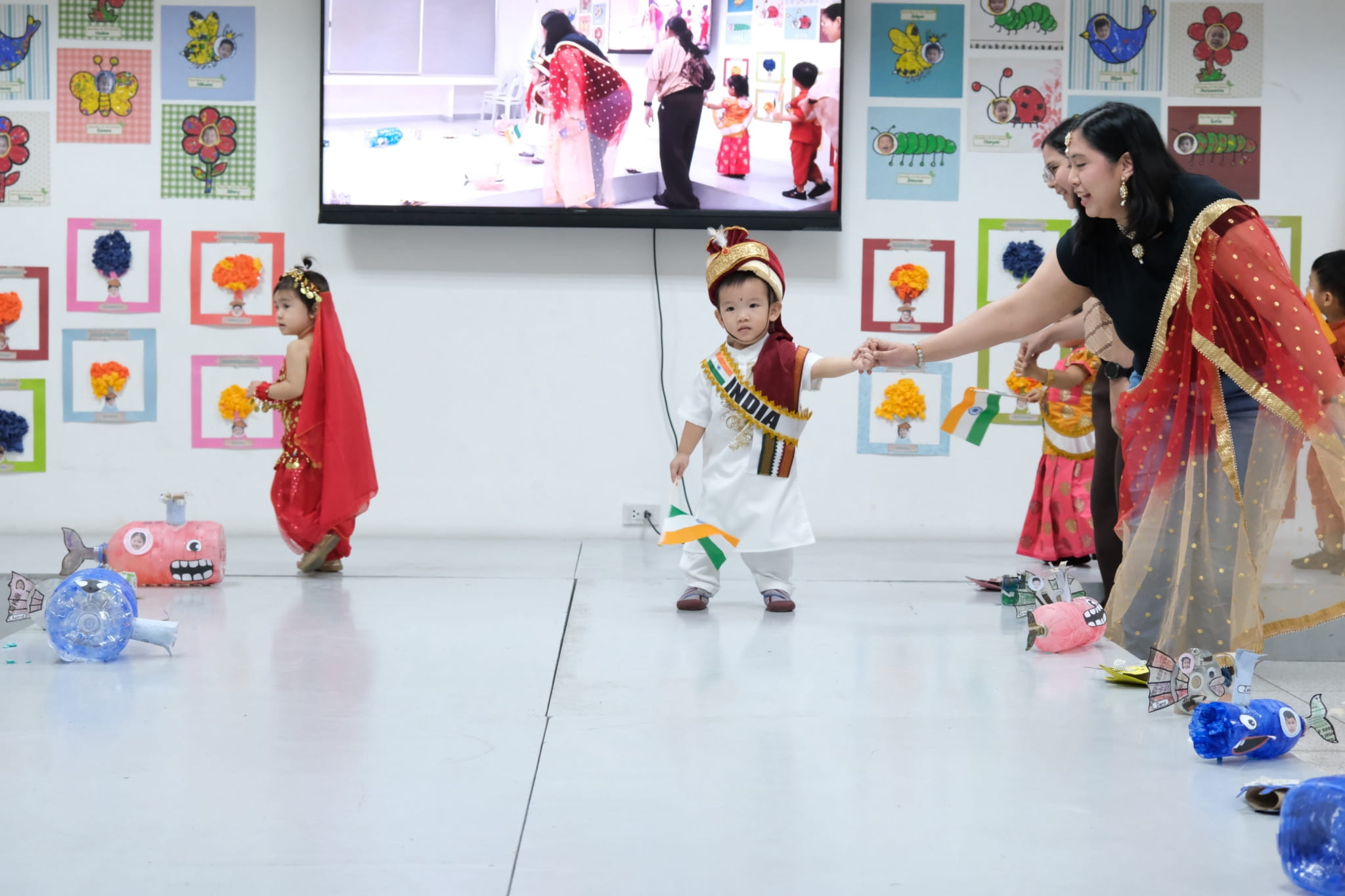 Preschoolers steal the spotlight in their colorful traditional costumes.