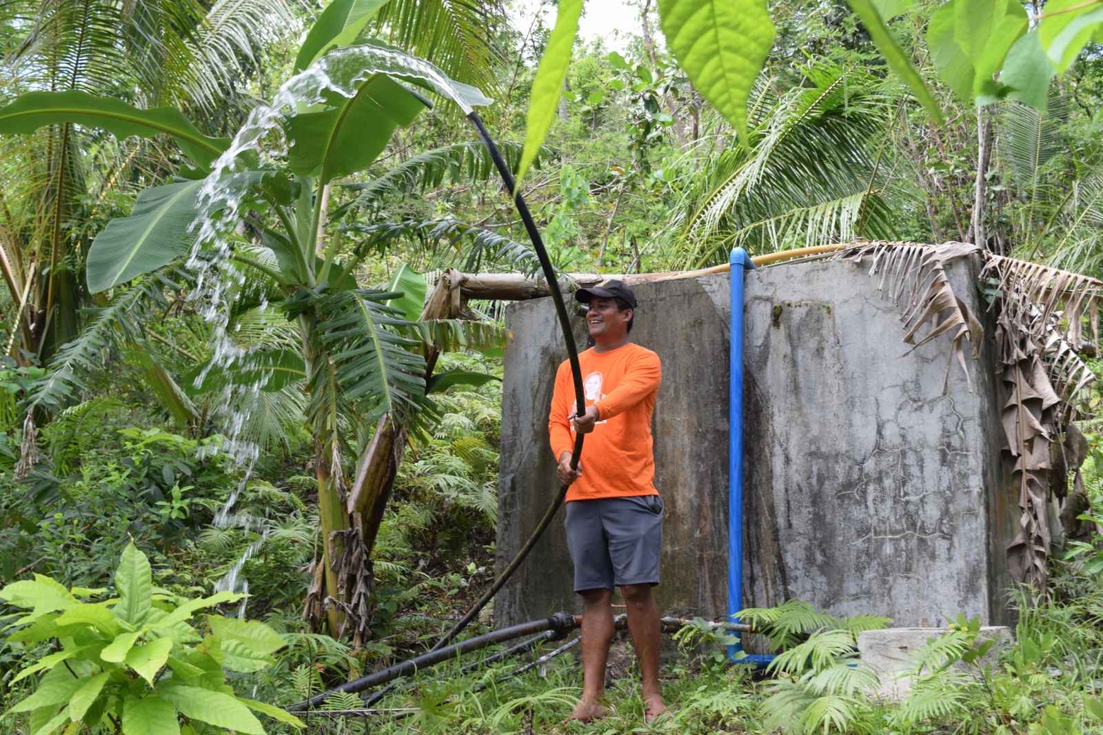 Marcelo Oracion, head of Barangay Oy in Loboc, cannot hide his glee at the strong water pressure coming out of a hose.