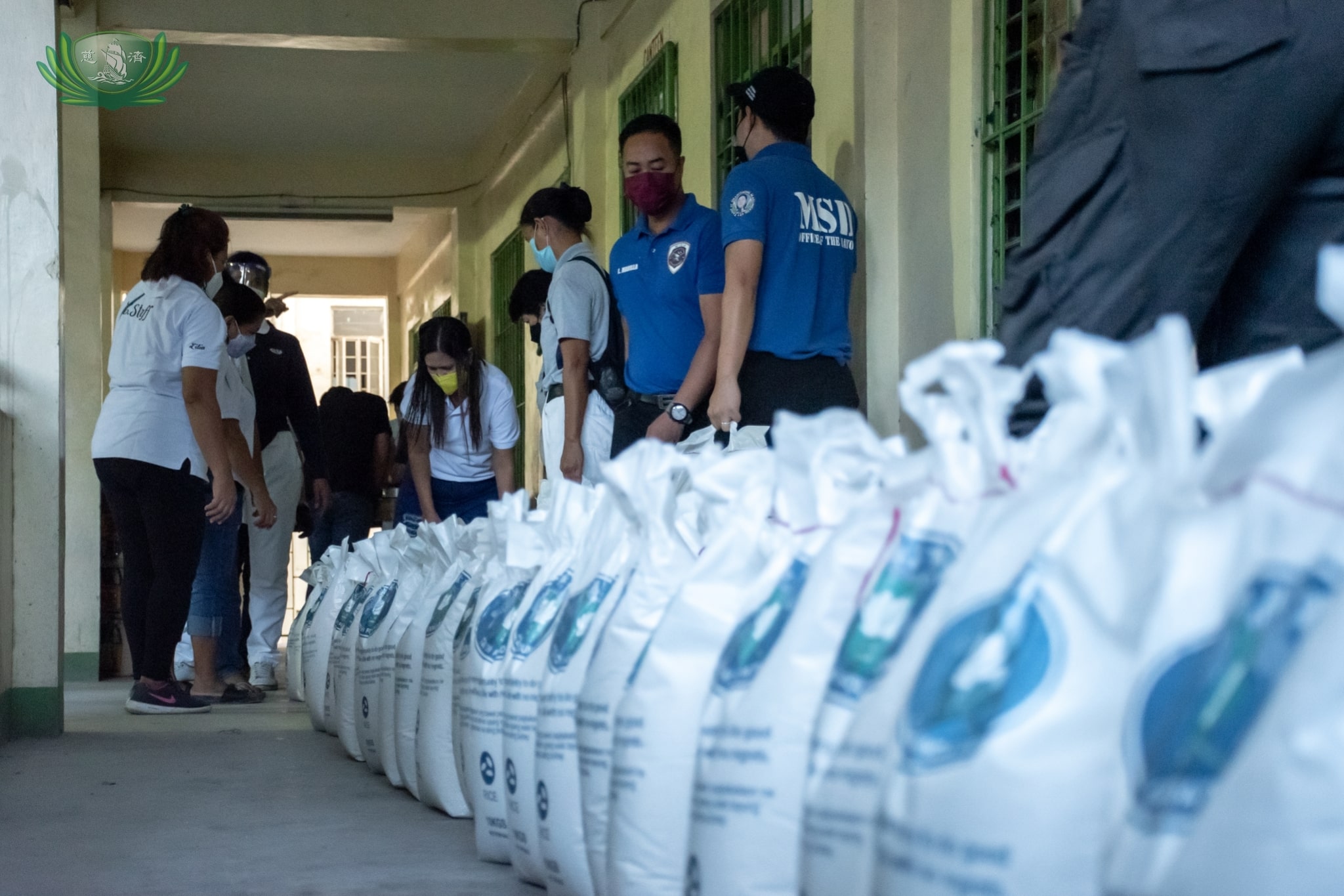 Sacks of rice are lined up for beneficiaries to claim.