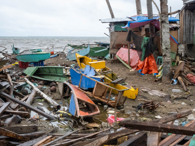 Fishing boats lie in disarray, damaged beyond repair. 【Photo by Marella Saldonido】