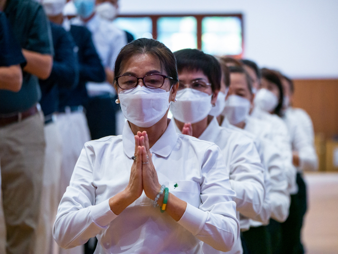 Volunteers put their palms together in prayer, a common gesture of the Lotus Sutra Adaptation.【Photo by Daniel Lazar】