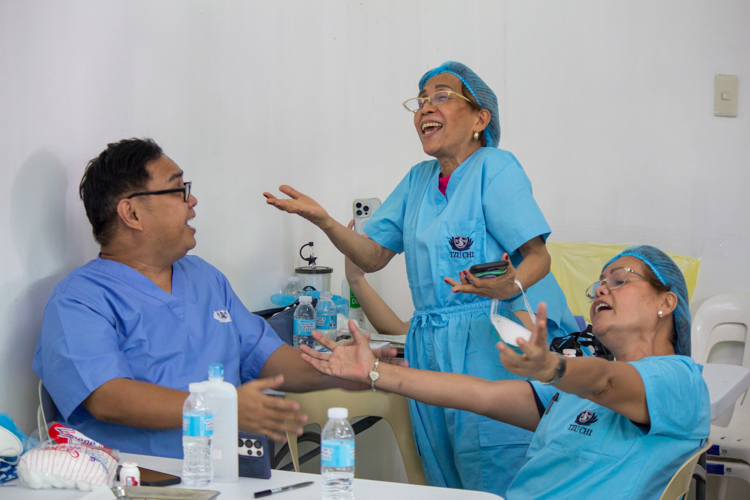 Three Tzu Chi volunteer dentists, all part of a singing group, break into song during downtime at the medical mission. 【Photo by Marella Saldonido】