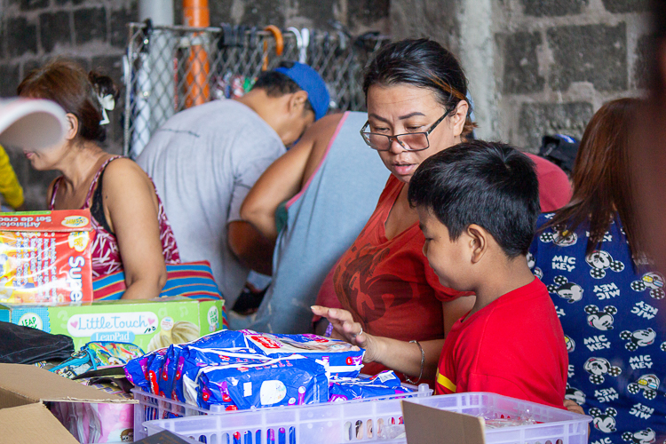 A mother and child go through the items available. 【Photo by Marella Saldonido】