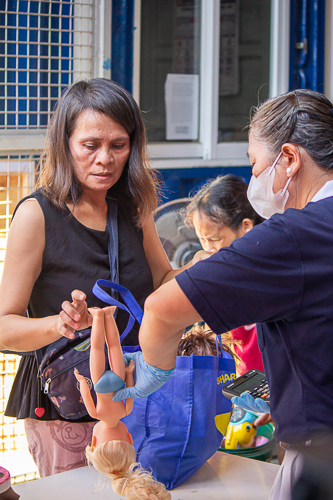 A Tzu Chi volunteer helps the customer pack her purchased items at the bazaar. 【Photo by Marella Saldonido】