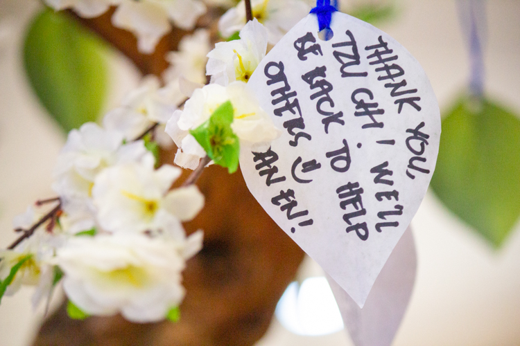 After writing letters to themselves, scholars fold their papers into a boat and place them in a candle-lined space, while others hang their leaf-shaped letters on tree branches.
