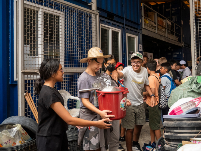 ISM middle school students work together in loading the packed relief goods into the truck. 【Photo by Dorothy Castro】