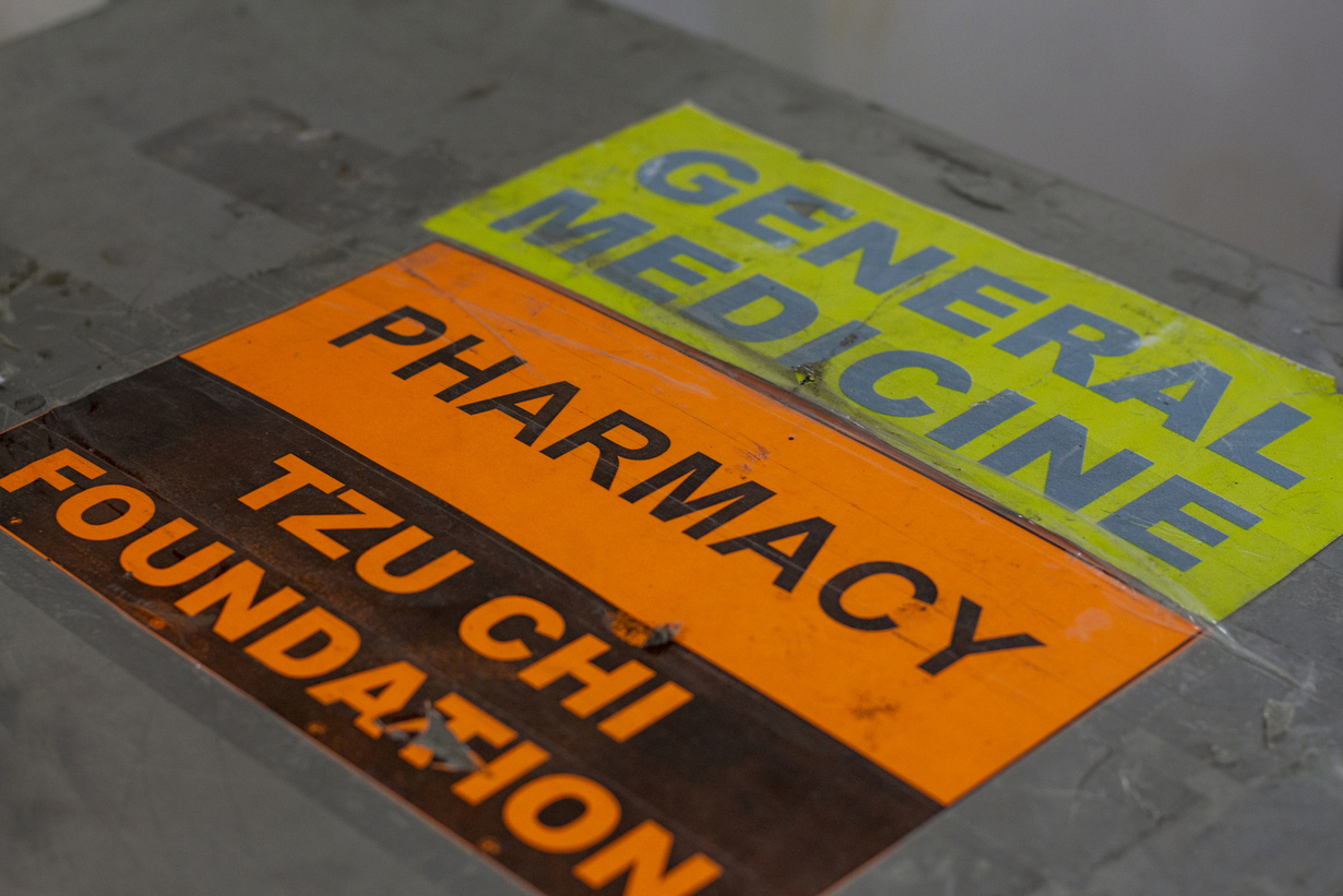 The ‘general medicine’ and ‘pharmacy’ signage of Tzu Chi Foundation at the medical mission.