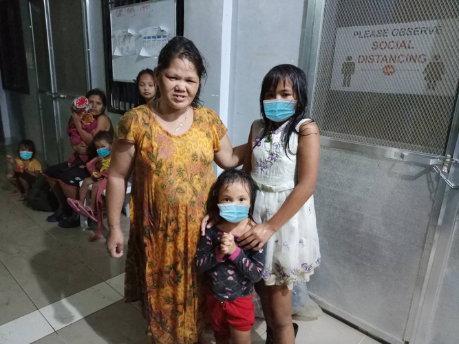 Soaking wet, a woman and two girls are grateful to take cover at an evacuation center in Barangay Liloan. 