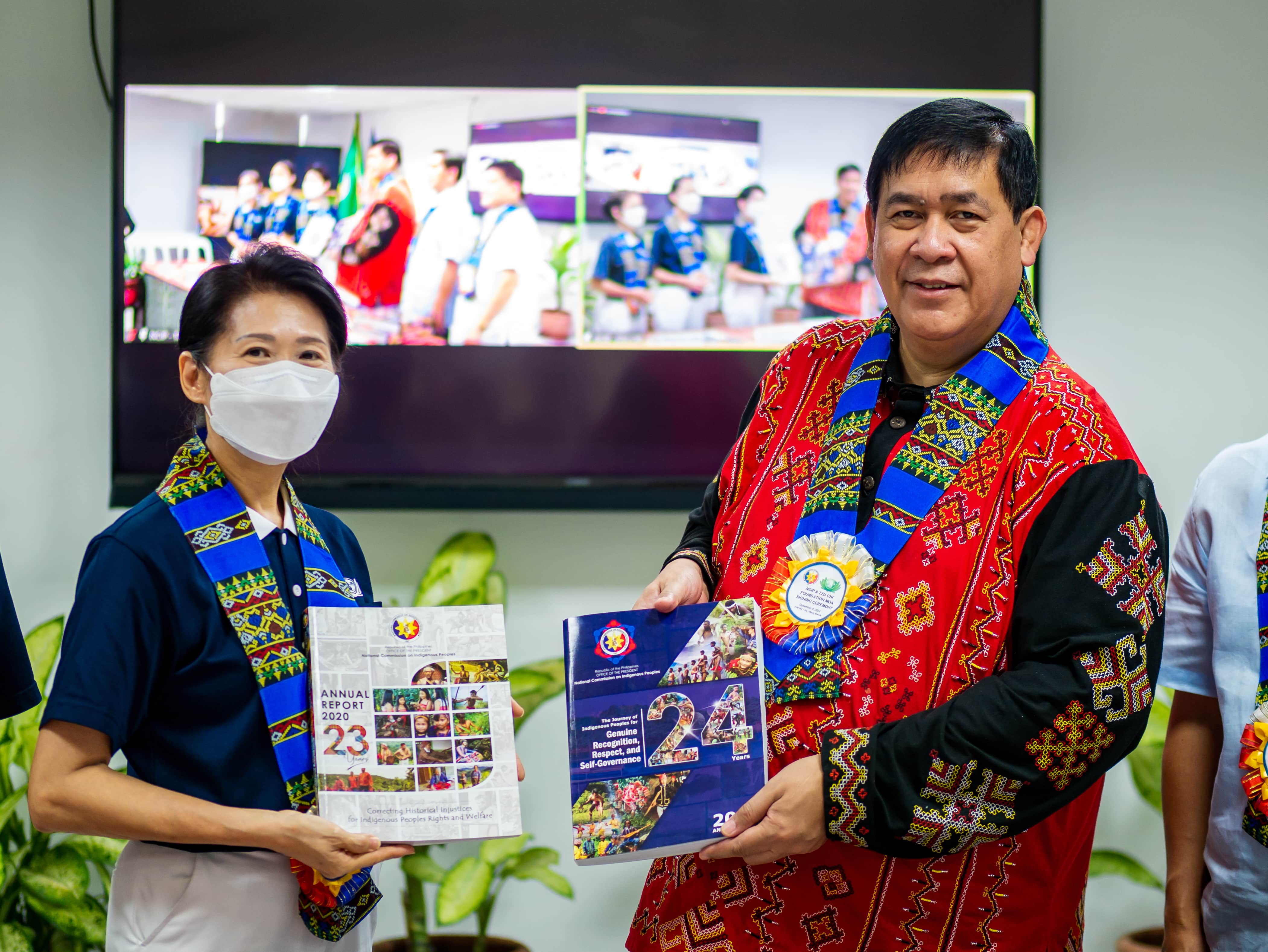 Chairperson Allen Capuyan presenting NCIP's annual reports to Deputy CEO Woon Ng.【Photo by Daniel Lazar】