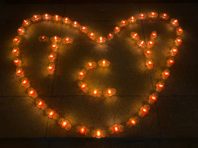 Candles form Tzu Chi Youth initials inside a heart. 【Photo by Matt Serrano】