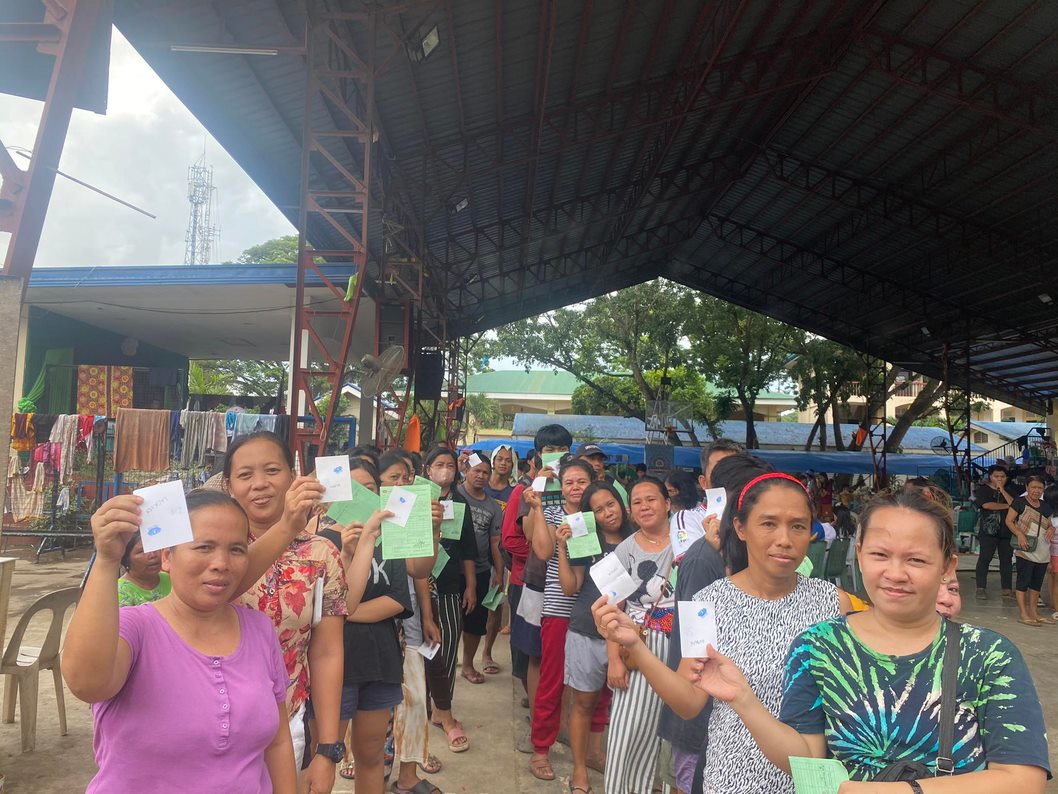 Evacuees from Talon-Talon Elementary School line up carrying their relief stubs.