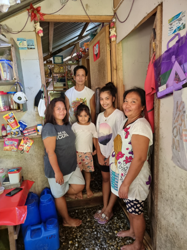 Successful applicant from Zamboanga Evaneza Vicente (2nd from right) with her family during a volunteers’ home visit.