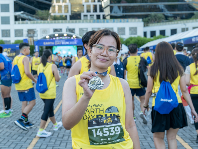 Over 60 Tzu Chi volunteers participated in this year’s Galaxy Watch Earth Day Run organized by Runrio. Here, some of them proudly display their finisher medals. 【Photo by Matt Serrano】