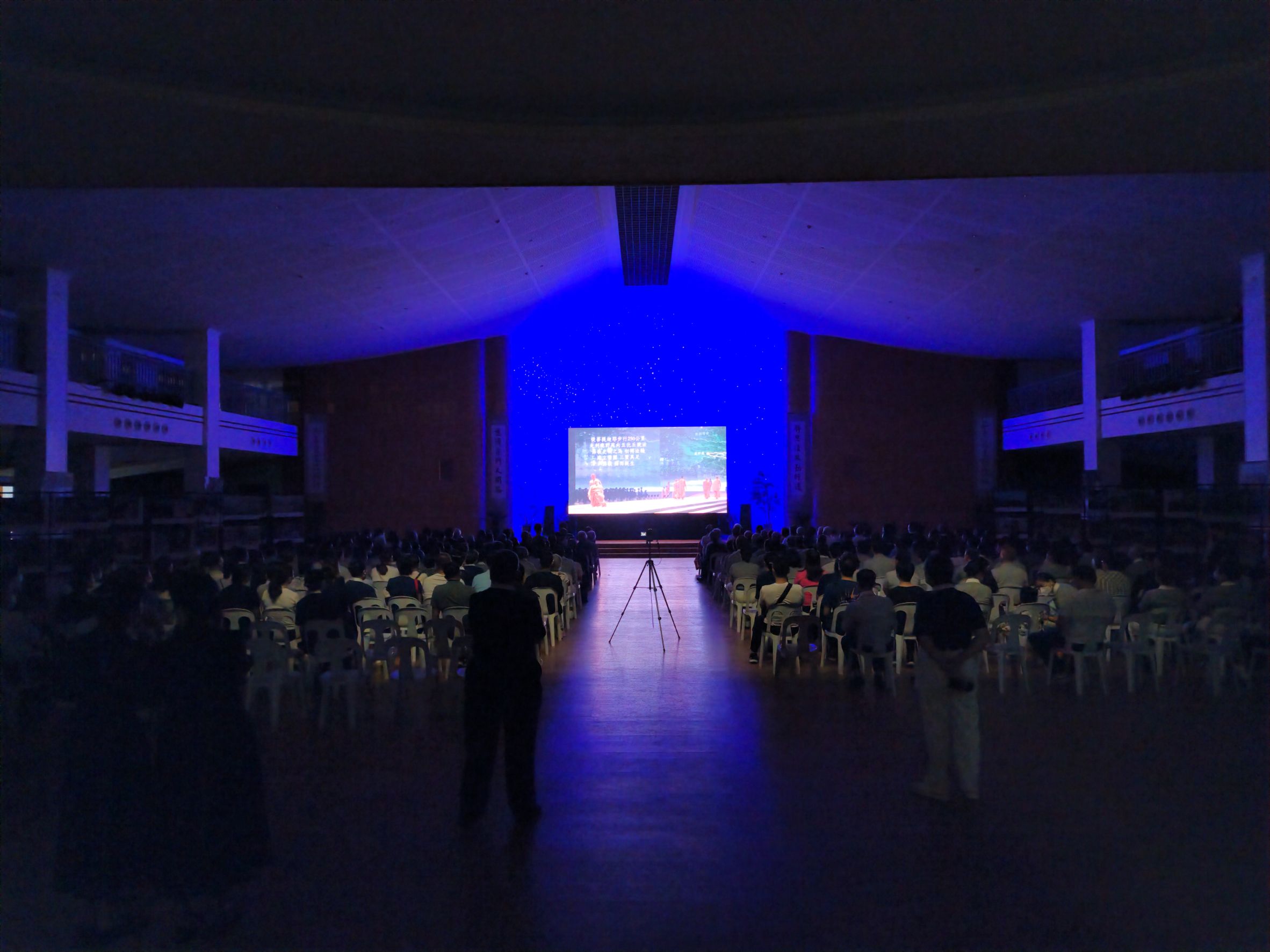 Viewers watch the Lotus Sutra Musical Adaptation streamed live from Taiwan through a large LED screen.