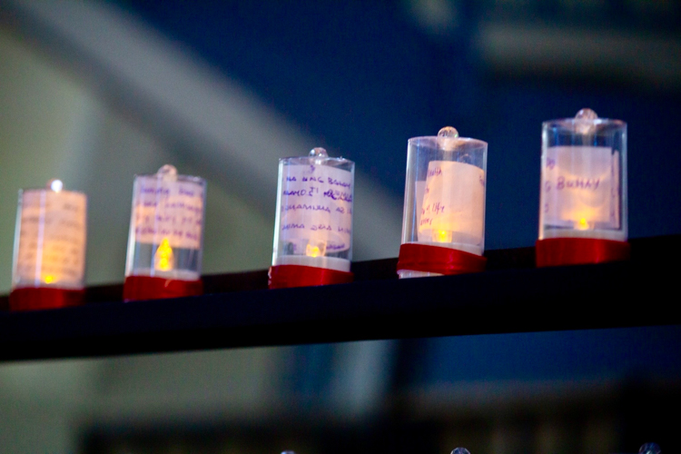 Guests write and wrap their prayers into a candle at the wishing wall. 【Photo by Marella Saldonido】