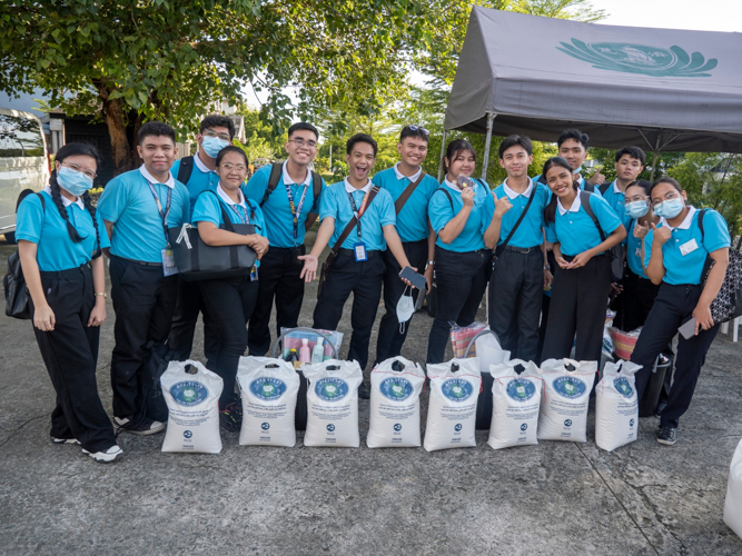 Tzu Chi scholars are grateful to receive their regular rice allowance.