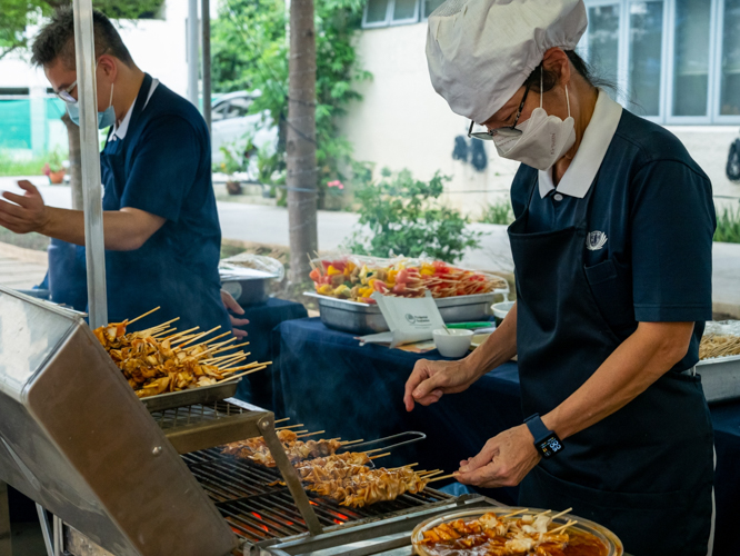 Tzu Chi volunteers serve grilled vegetarian skewers at the BTCC plaza. 【Photo by Daniel Lazar】