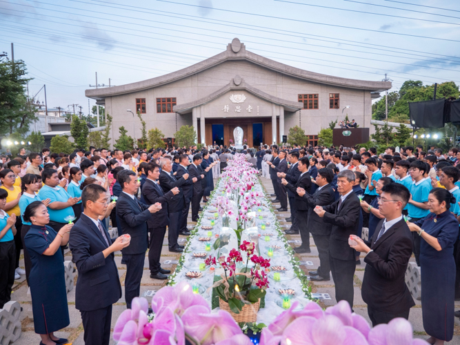 Volunteers offer candles as symbols of inner light and gratitude to the Buddha, loved ones, and all beings.