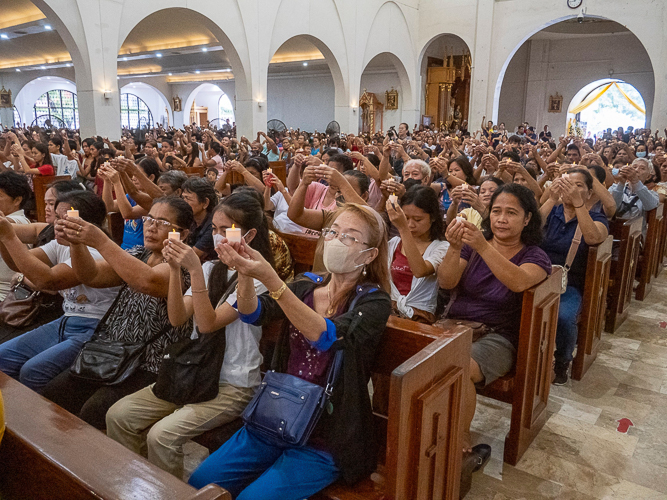 The program culminates on a hopeful note as the congregation raises their candles in a solemn prayer. 【Photo by Matt Serrano】
