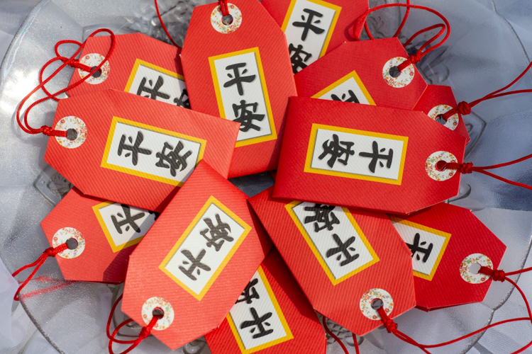 Blessing charms are claimed by participants during the Buddha Bathing Ceremony. 【Photo by Matt Serrano】