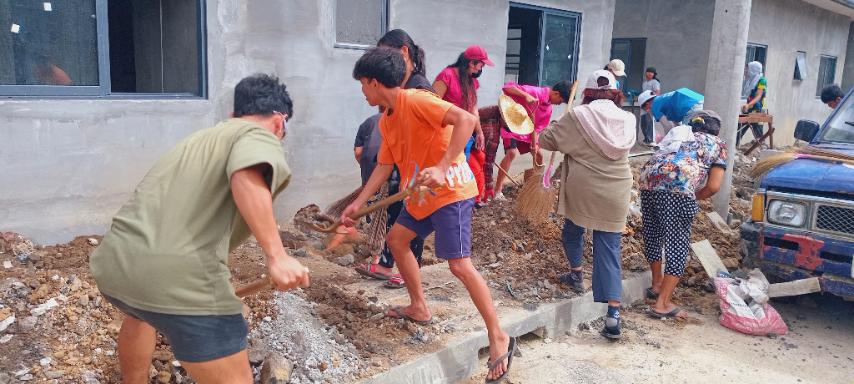 Men, women, and children of all ages spend their Black Saturday preparing the front of homes in Tzu Chi Great Love Village for tiling.