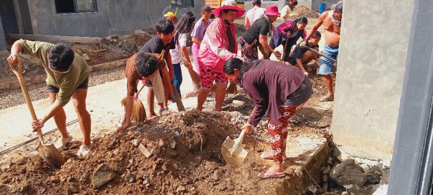 Men, women, and children of all ages spend their Black Saturday preparing the front of homes in Tzu Chi Great Love Village for tiling.